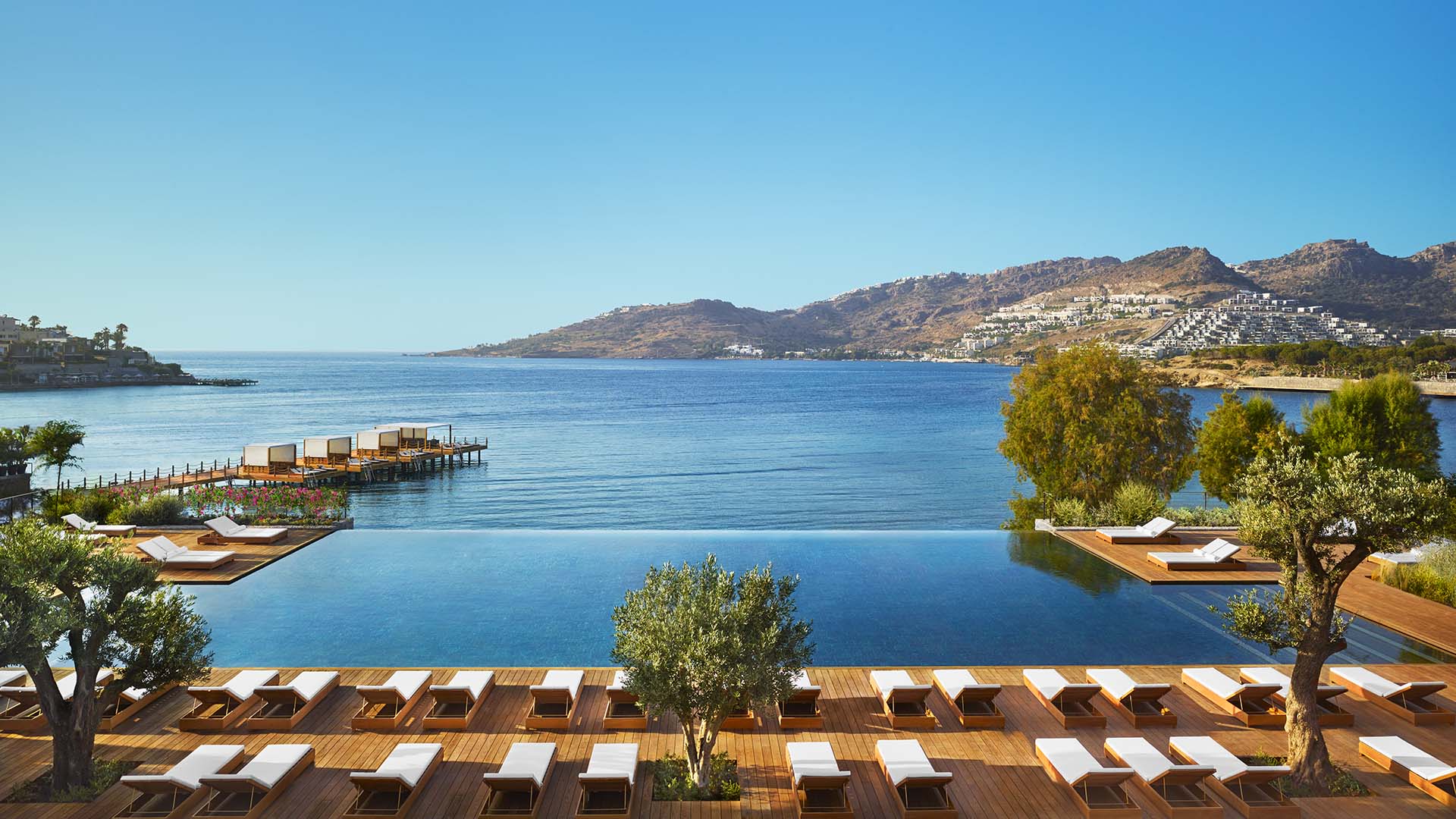infinity pool with views of mountains and sea at Bodrum EDITION hotel in Türkiye