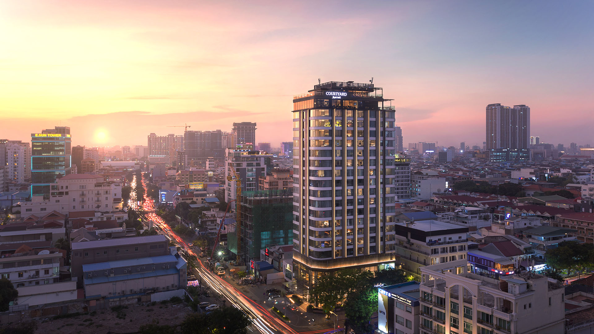 Phnom Penh Courtyard hotel and city at sunset