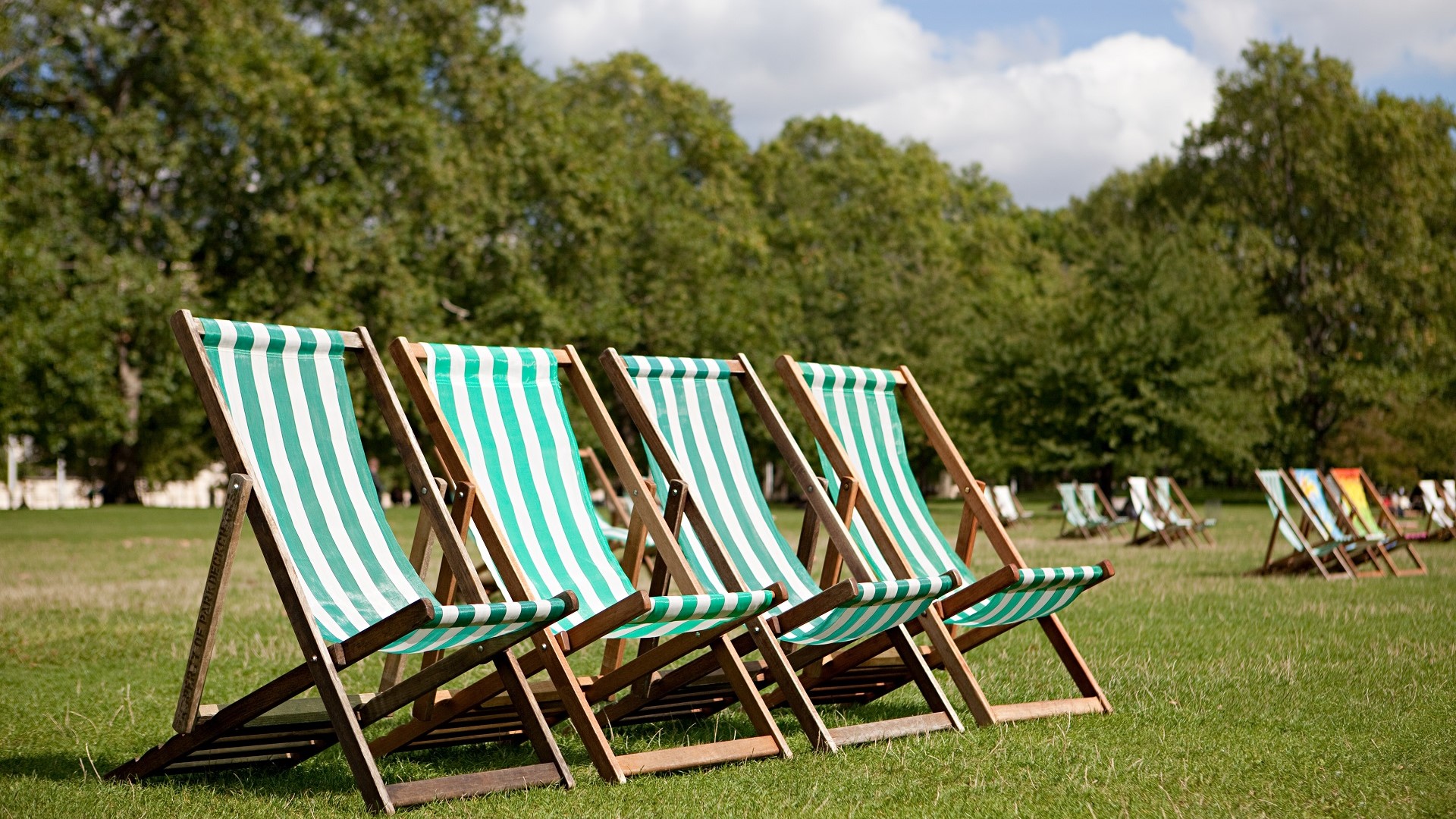 striped lawn chairs in a park in London