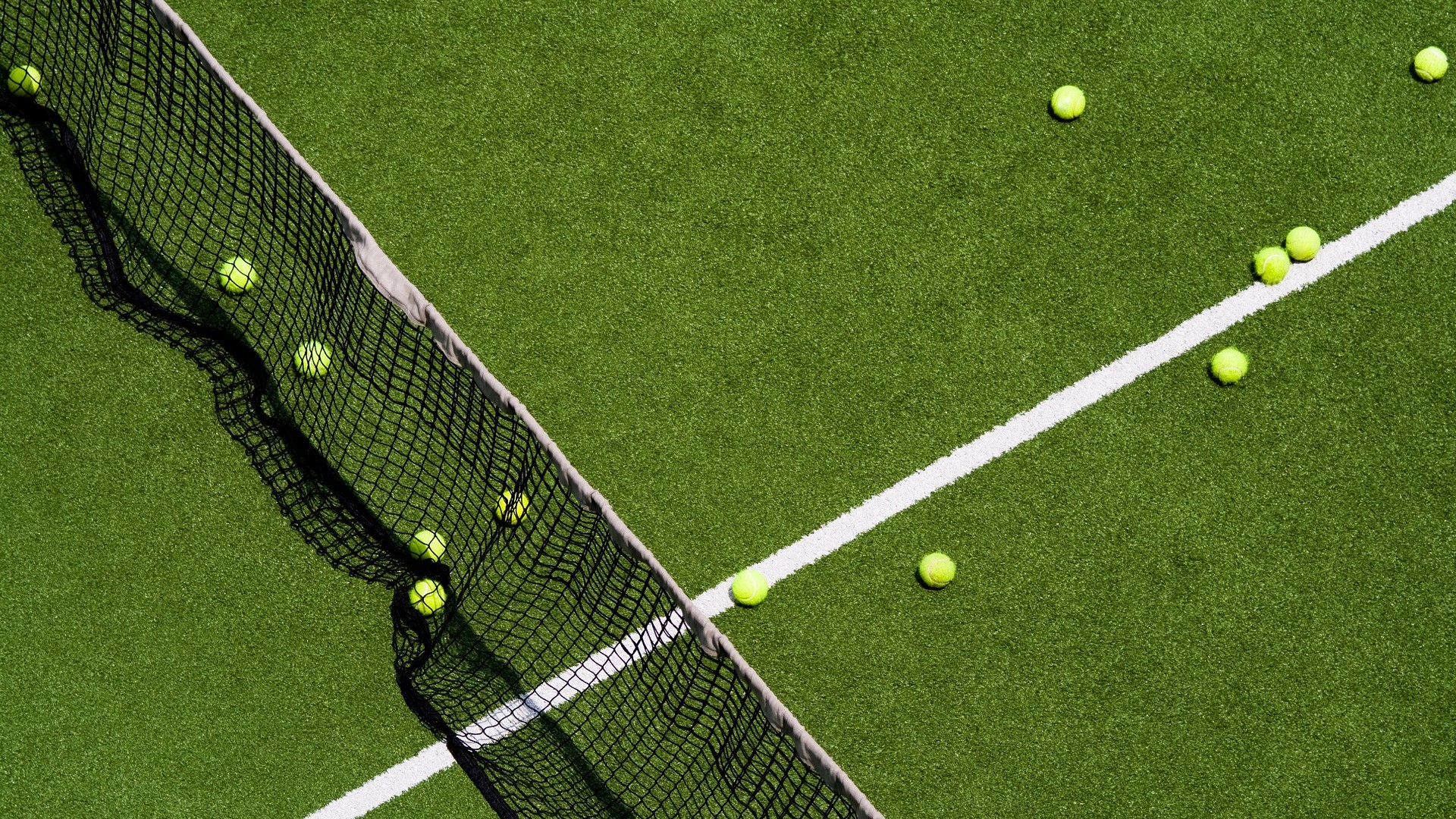grass tennis court with tennis balls