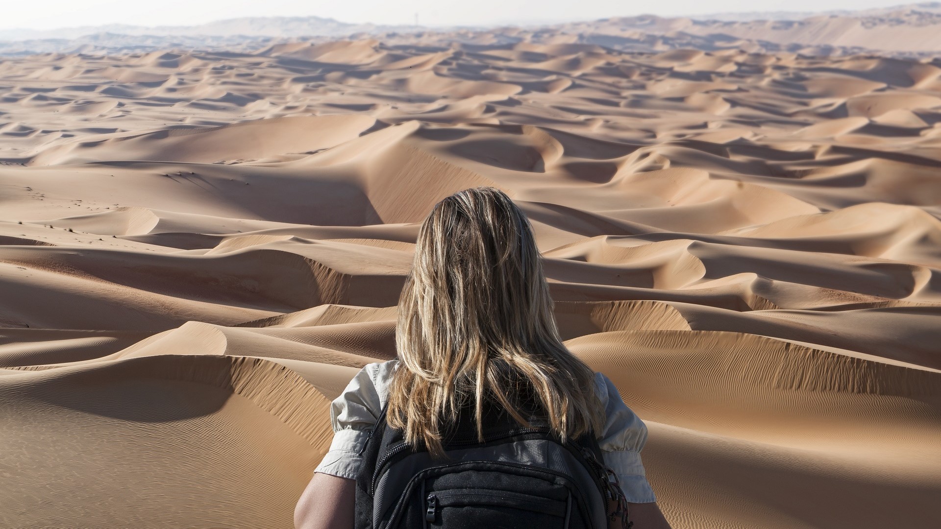 female solo traveler hiking in Abu Dhabi desert