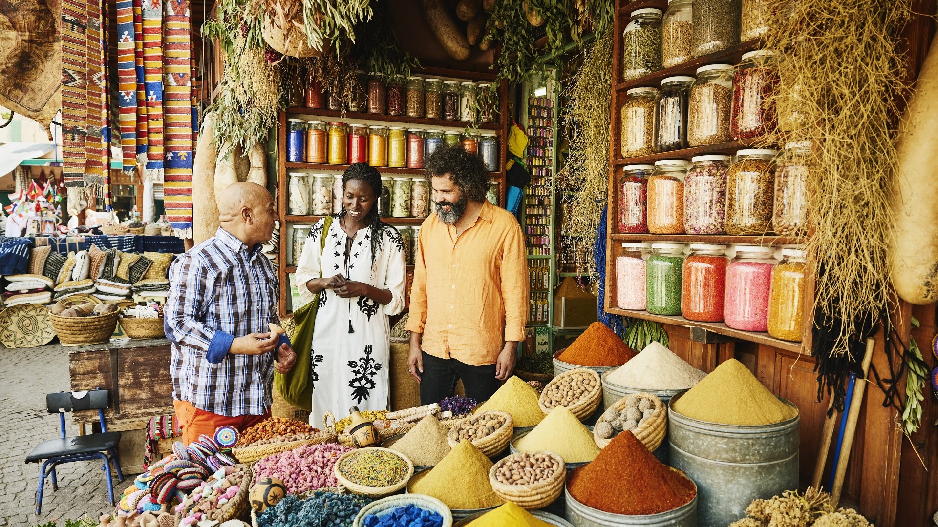 couple and spice seller looking at spices in a Marrakesh souk