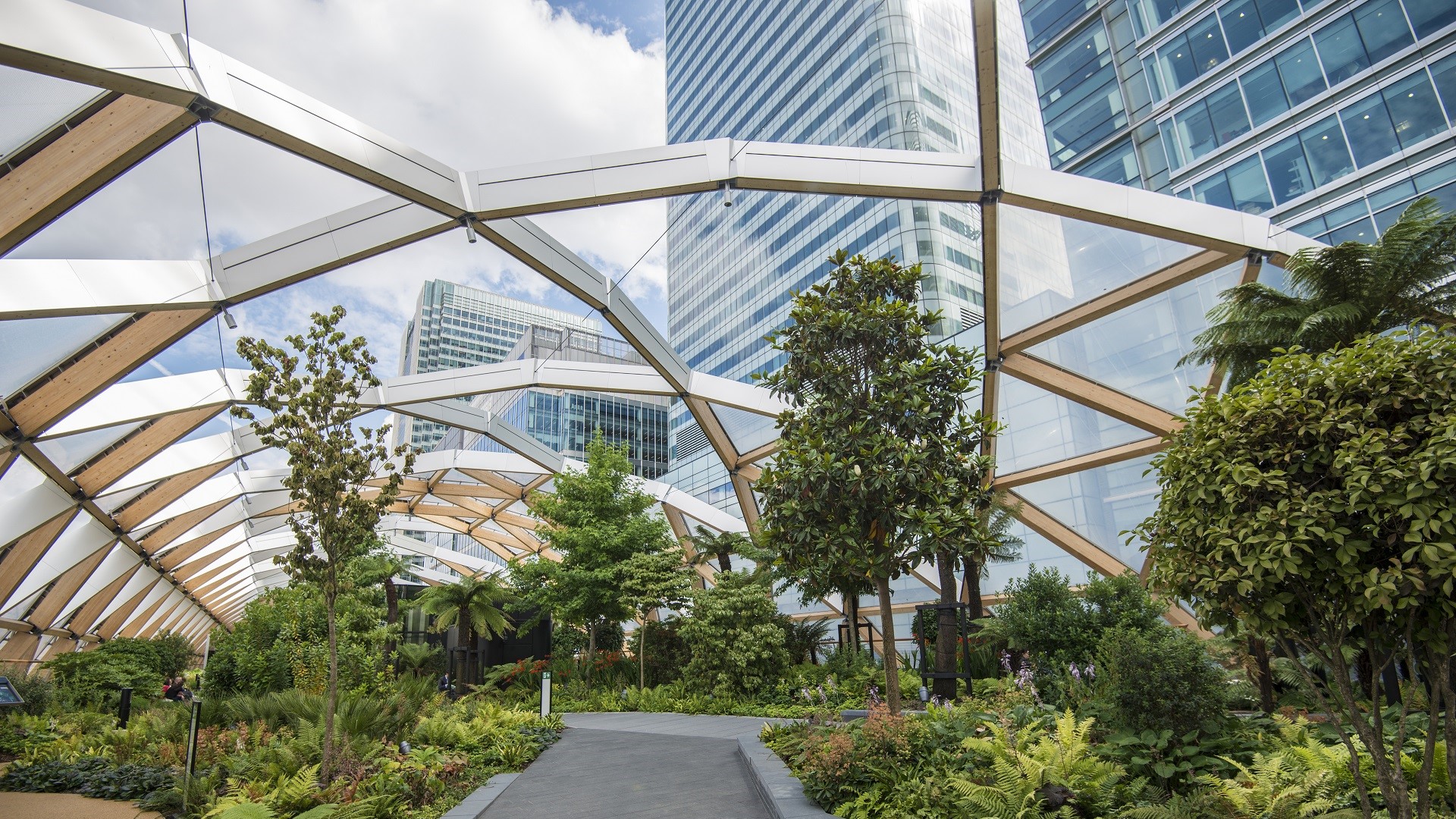 garden with a dome roof surrounded by skyscrapers in London