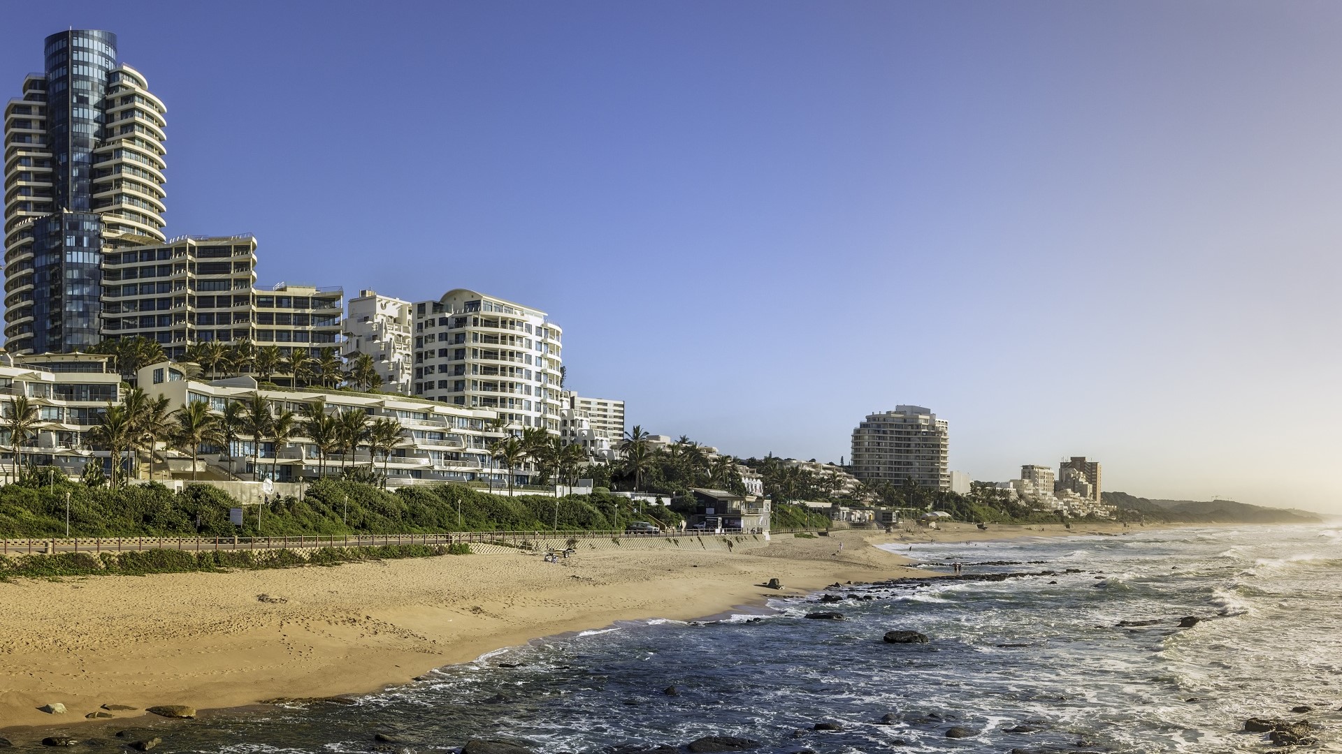 waves on the Indian Ocean shore with high-rises in Durban, South Africa