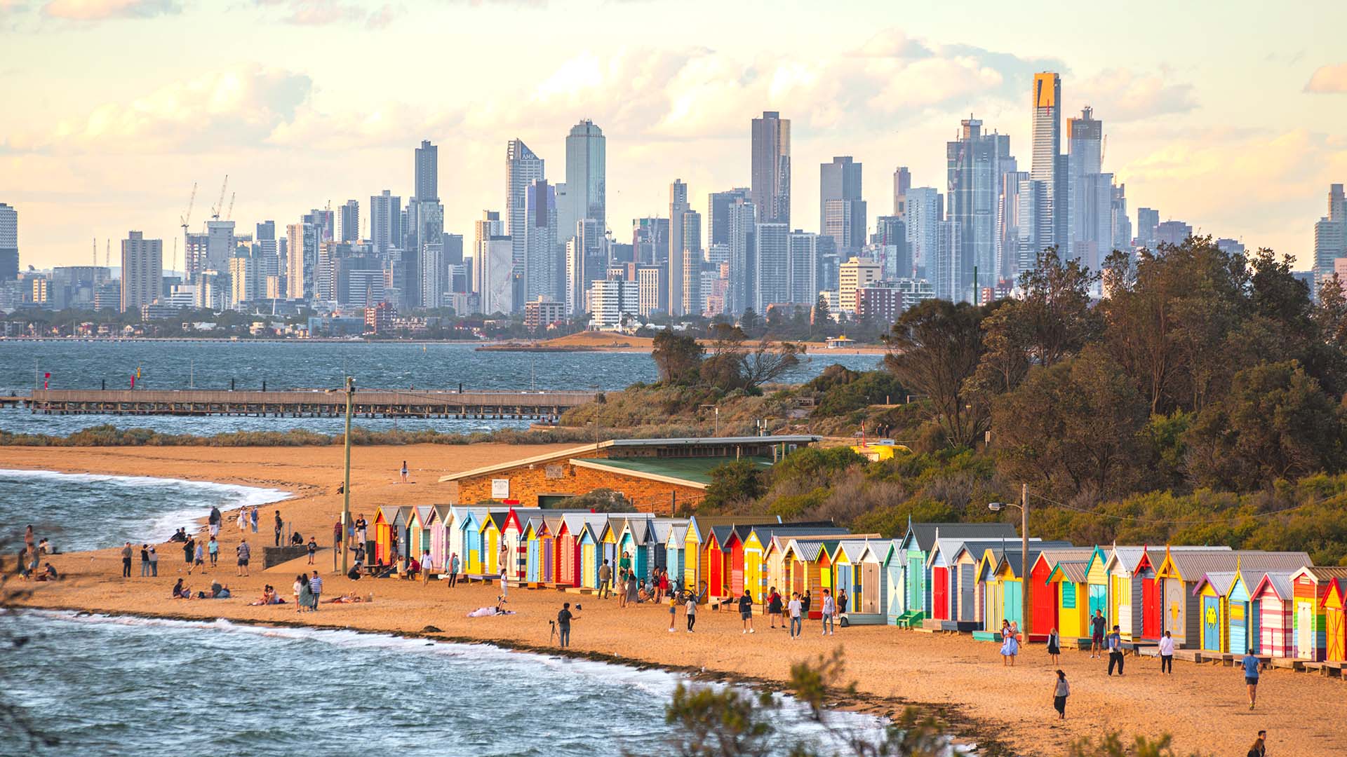 Melbourne Australia skyline from Brighton's beach and colorful bathing boxes