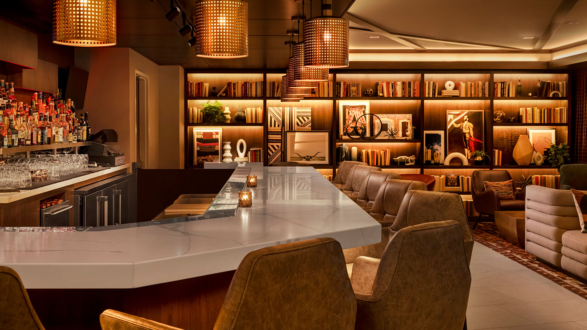 marble bar and wooden bookshelves at The Otis Hotel Austin, Autograph Collection