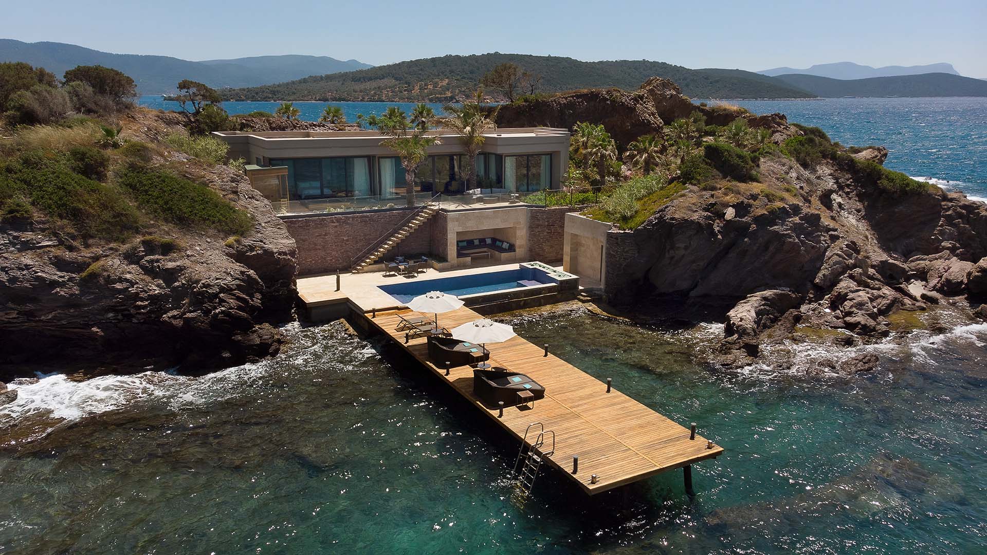 dock and private pool on the rocky Aegean coast at the Secluded Bay Villa at Le Méridien Bodrum Beach Resort