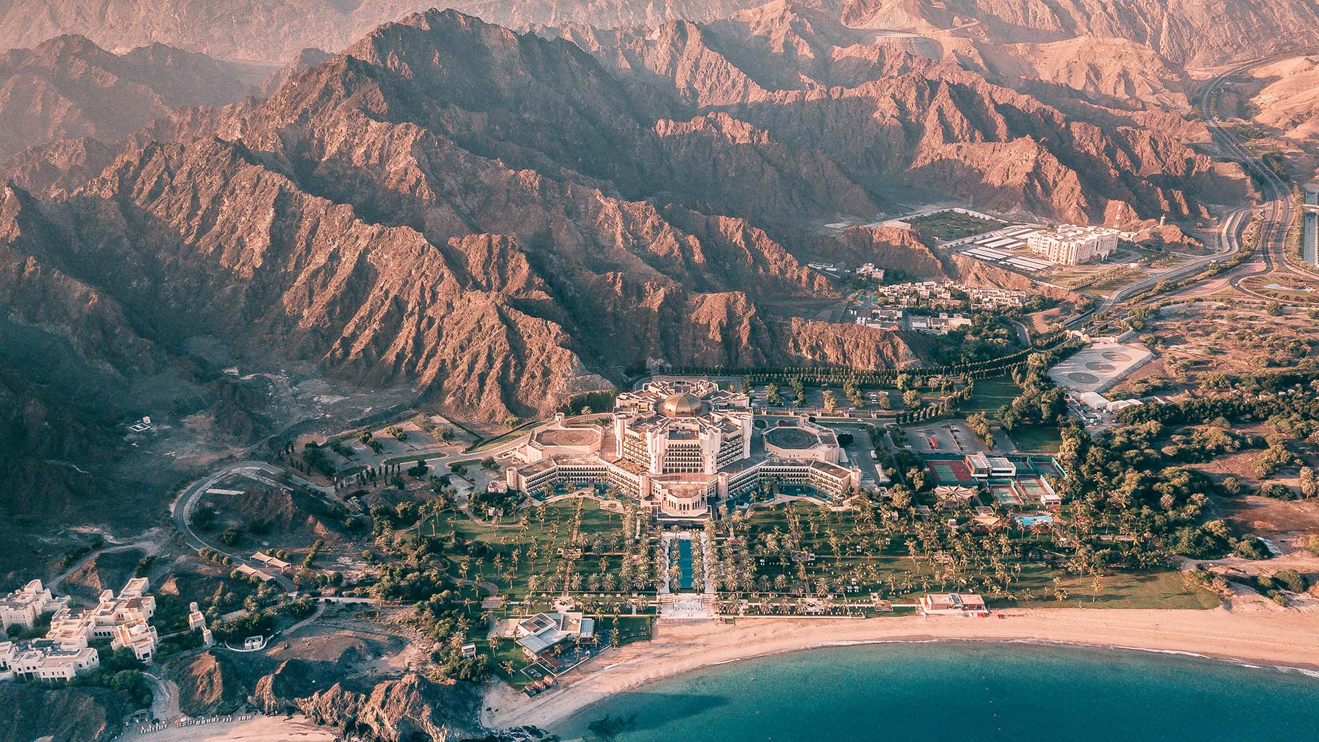 Al Bustan Palace, a Ritz-Carlton Hotel in Muscat, Oman aerial view of seaside and mountains