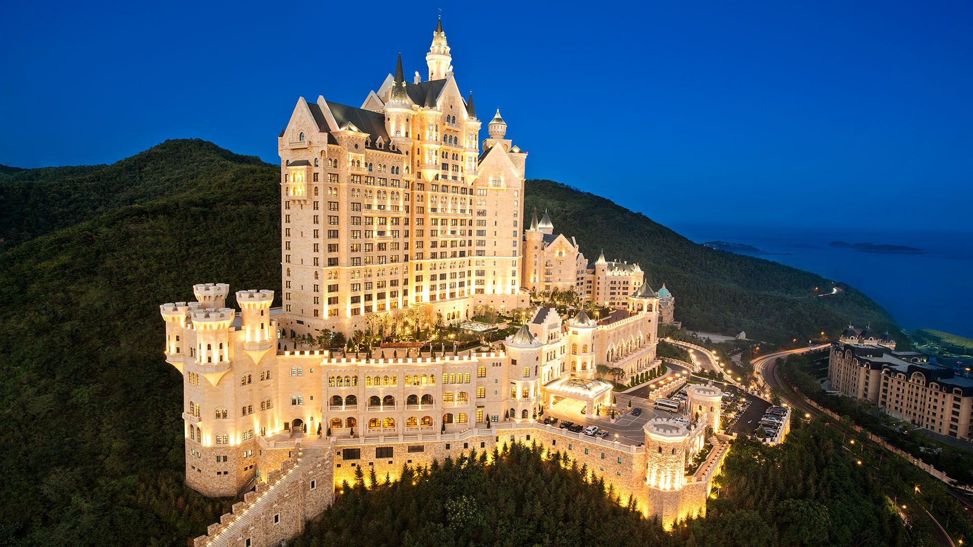 The Castle Hotel, a Luxury Collection Hotel, Dalian, China, Bavarian castle atop hill at night