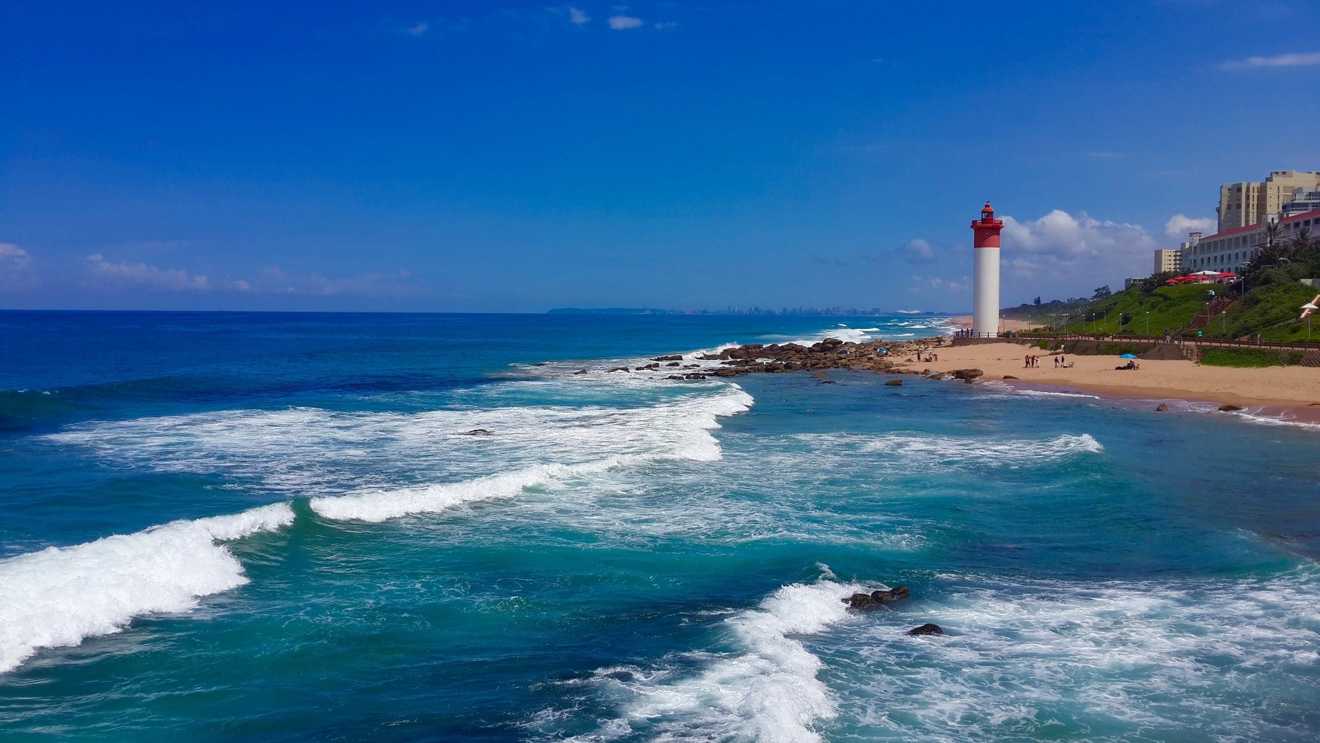 turquoise water beach and lighthouse on beach in South Africa at Umhlanga Rocks