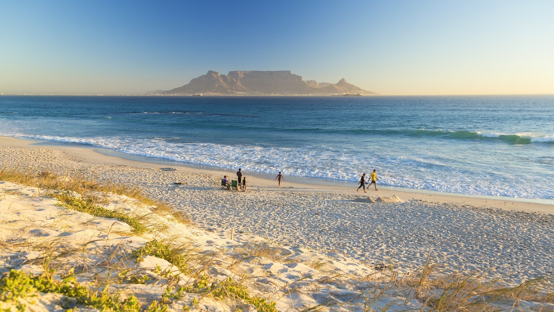 people walking on Bloubergstrand Beach, beach in South Africa near Cape Town