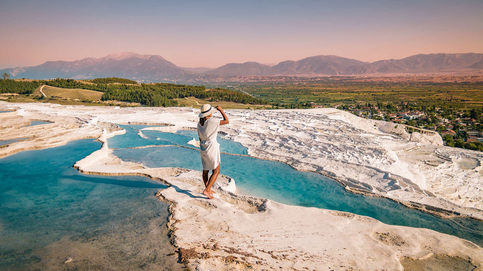 woman at the limestone pools in pamukkale, turkey.
