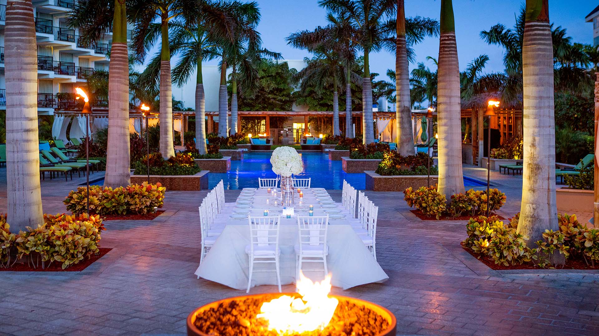 a view of a dining table set in a courtyard at the Aruba Marriott Resort & Stellaris Casino