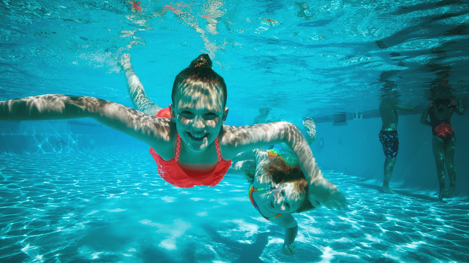 two children swim in a pool