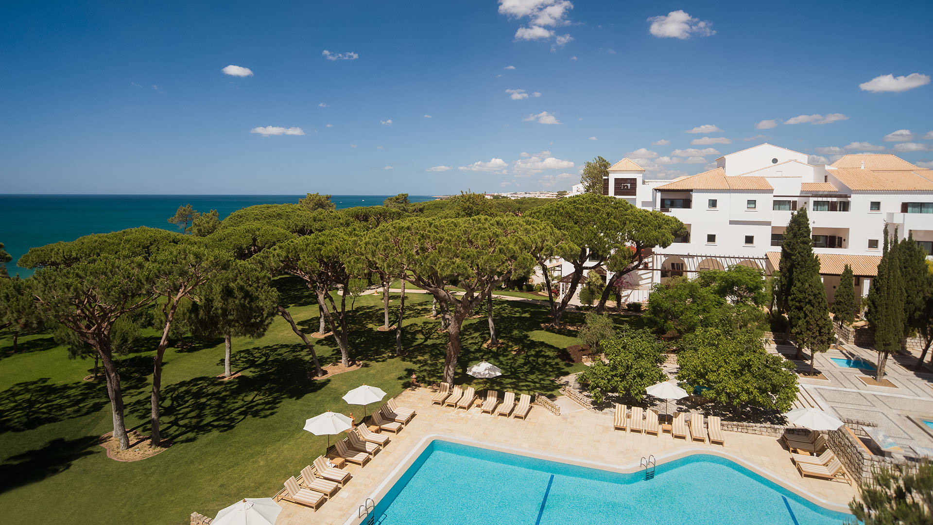 aerial view of the trees and a pool area at Pine Cliffs Hotel, a Luxury Collection Resort, Algarve