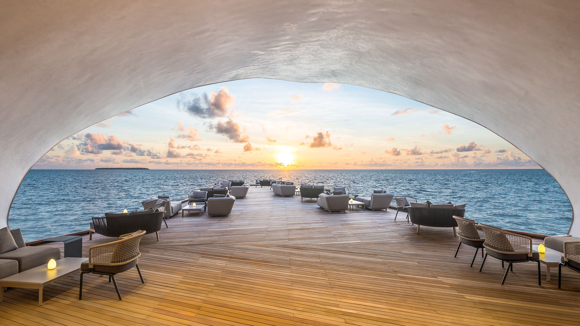 whale bar at st regis maldives vommuli dock with tables leading to water