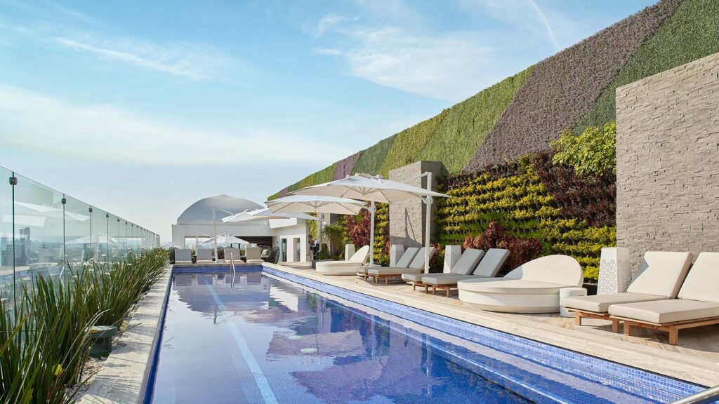 a rooftop swimming pool and lounge area The Westin Monterrey Valle