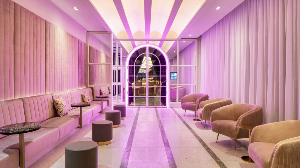 a lounge area with plush couches and chairs, as well as purple lighting at HONEYROSE Hotel, Montreal, a Tribute Portfolio Hotel