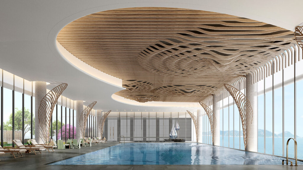 an indoor pool and lounge area with a dramatic sculptural ceiling at Le Méridien Ile Maurice