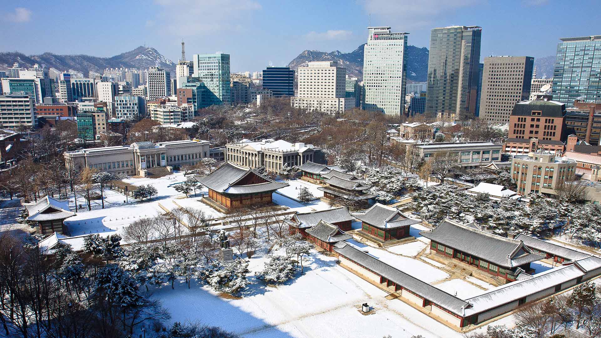 aerial view of snowy Seoul and Deoksugung Palace in the winter