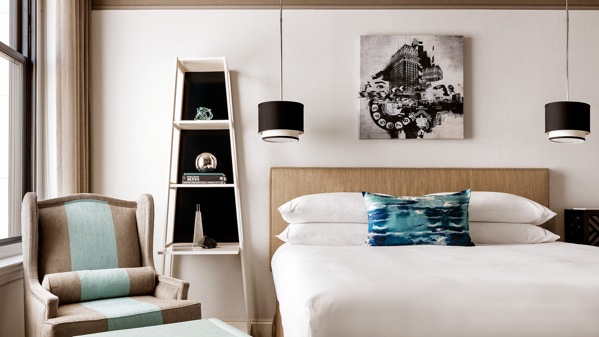a bed, chair, shelf, and other decor accents in a room at The Blackstone, Autograph Collection