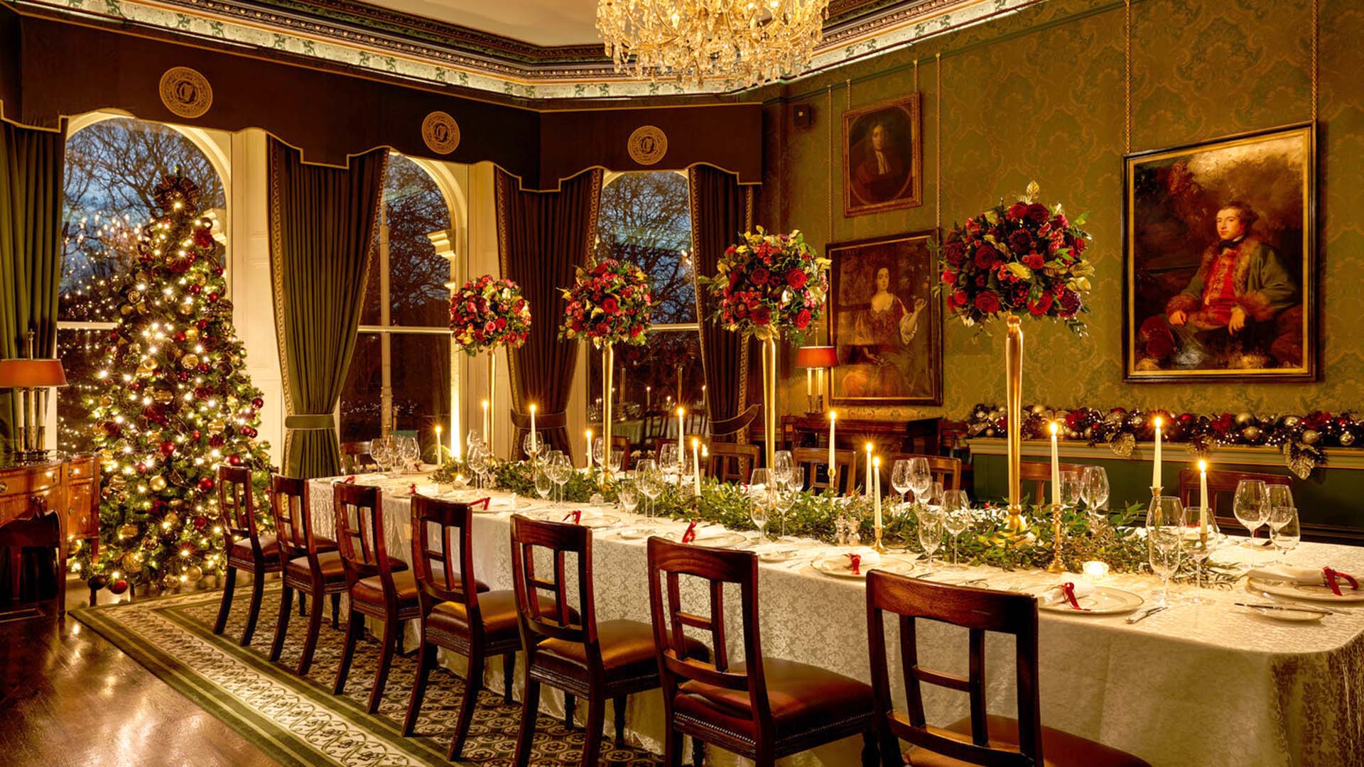 a formally set dining room with a Christmas tree and other seasonal decorations at The Shelbourne, Autograph Collection