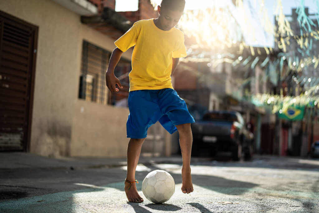 A boy playing with a soccer ball in Rio de Janeiro, Brazil