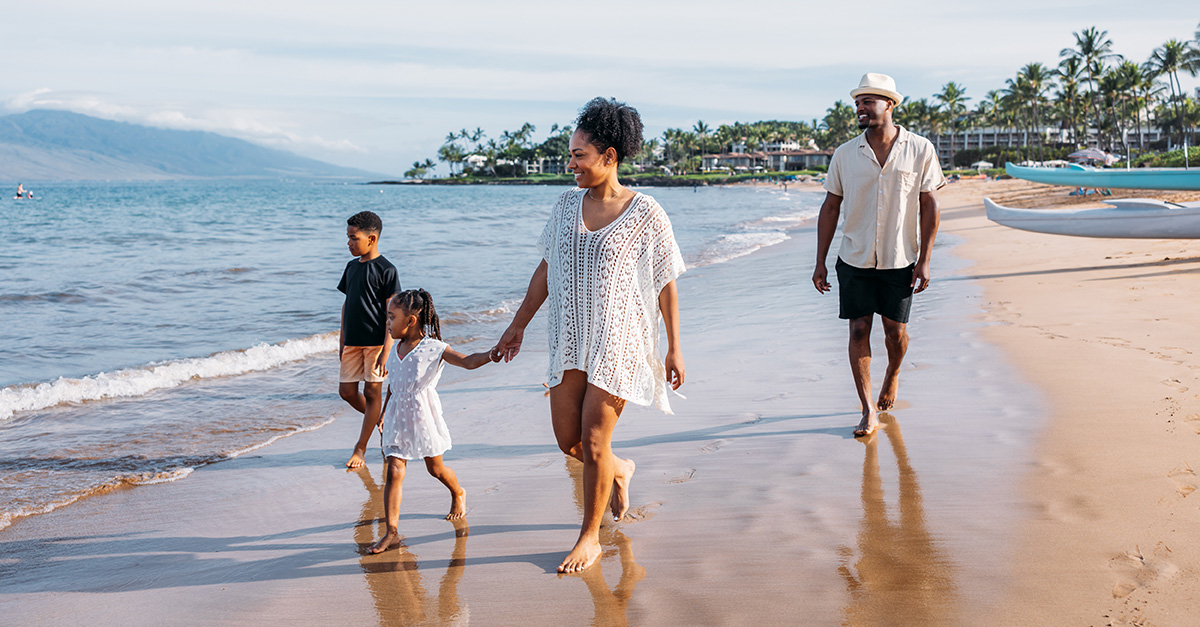 Two parents and two children walk on the beach at Wailea Beach Resort - Marriott, Maui