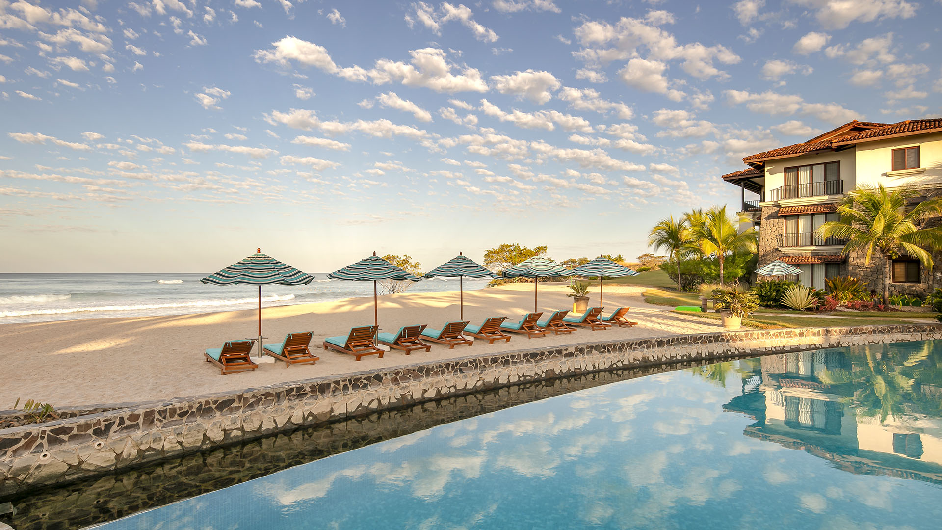 A view of a swimming pool and beach at JW Marriott Guanacaste Resort & Spa