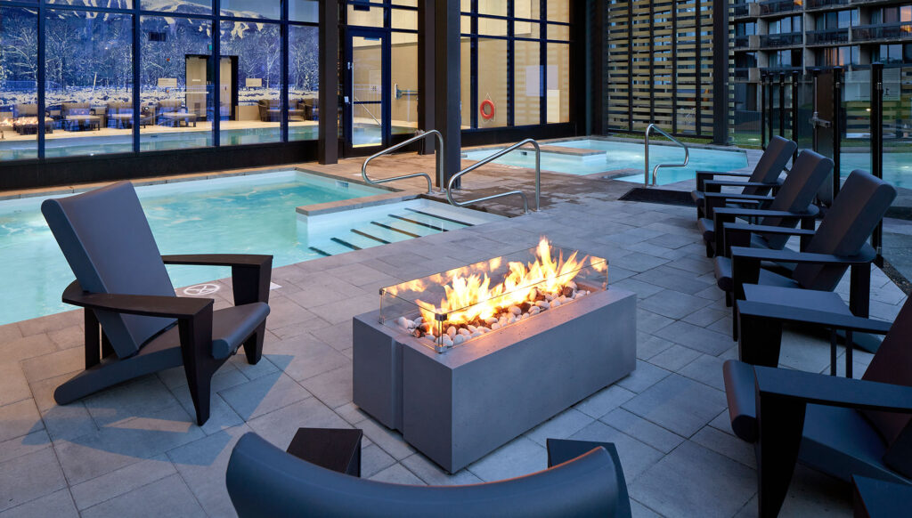 A fire pit, seating area, and pool at Delta Hotels by Marriott Mont Sainte-Anne, Resort & Convention Center