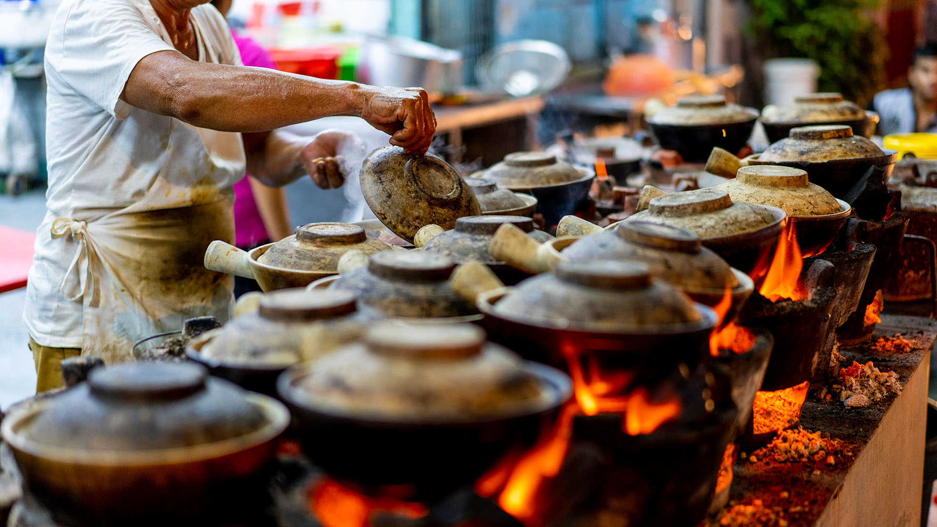 A vendor cooks street food in Singapore