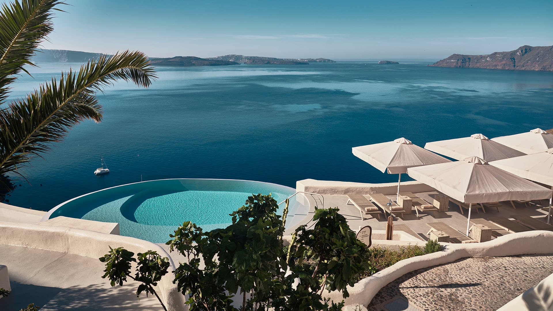 view of the infinity pool and sea, mystique santorini.