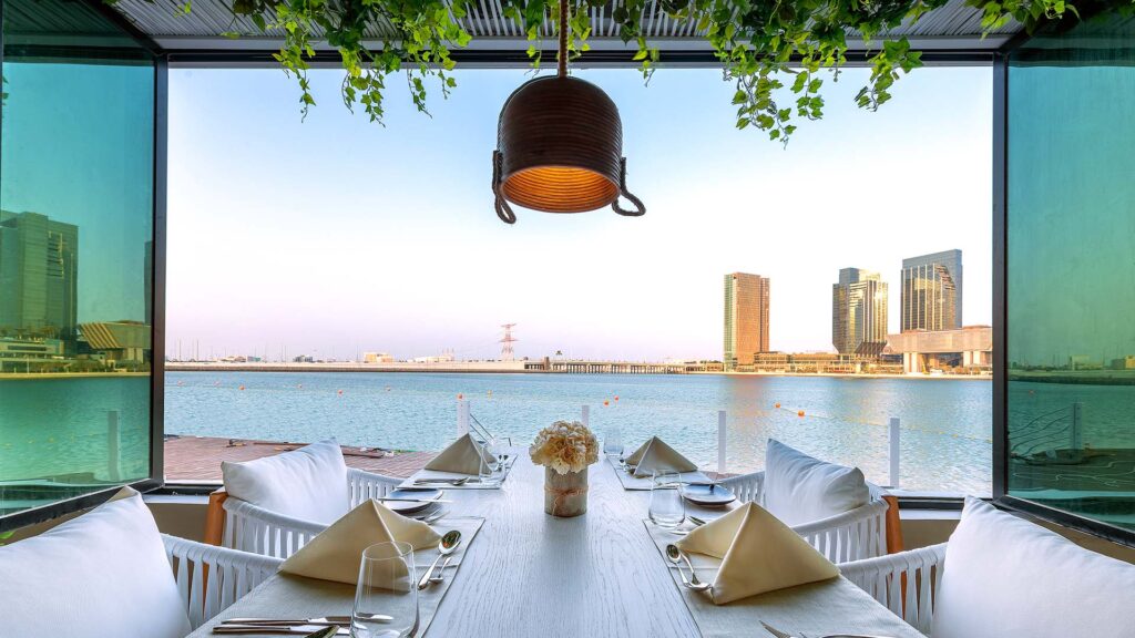 view of a restaurant along the water, let meridien abu dhabi