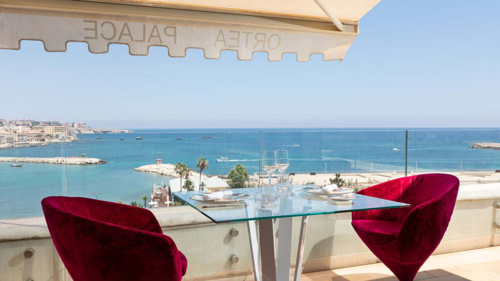 a dinner table with views of the sea, ortea palace