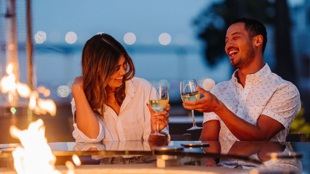 a couple having drinks by the fire, coronado island marriott resort and spa